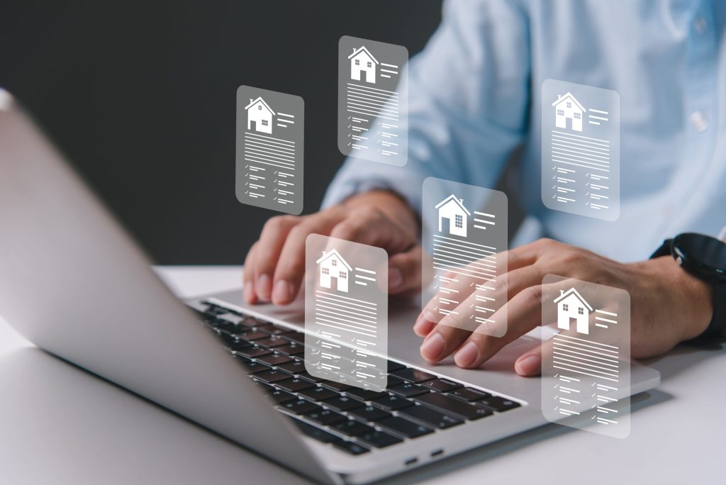 Person browsing digital listings for real estate investing on a laptop.