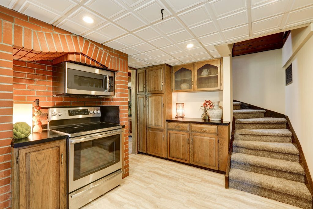Empty apartment with tiled floor, white walls, and counter. 