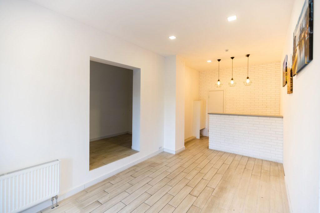 Modern empty room with tiled floor and counter.