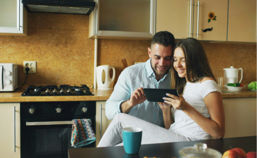 Couple relaxing in their kitchen, enjoying apartment living in Kerala