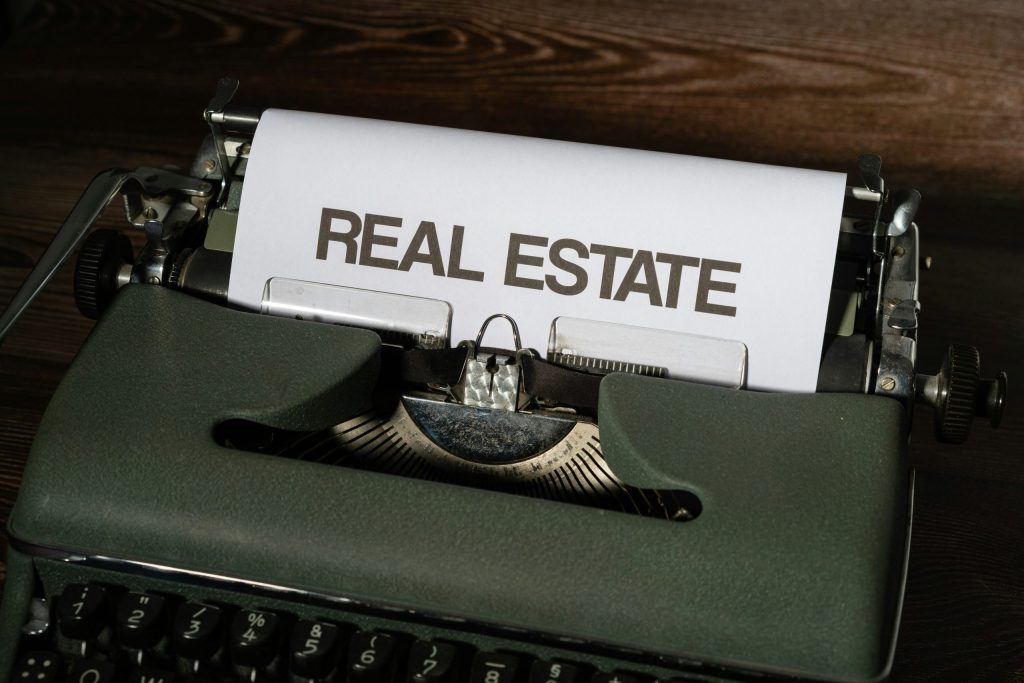 real estate investment advice concept with typewriter and paper text