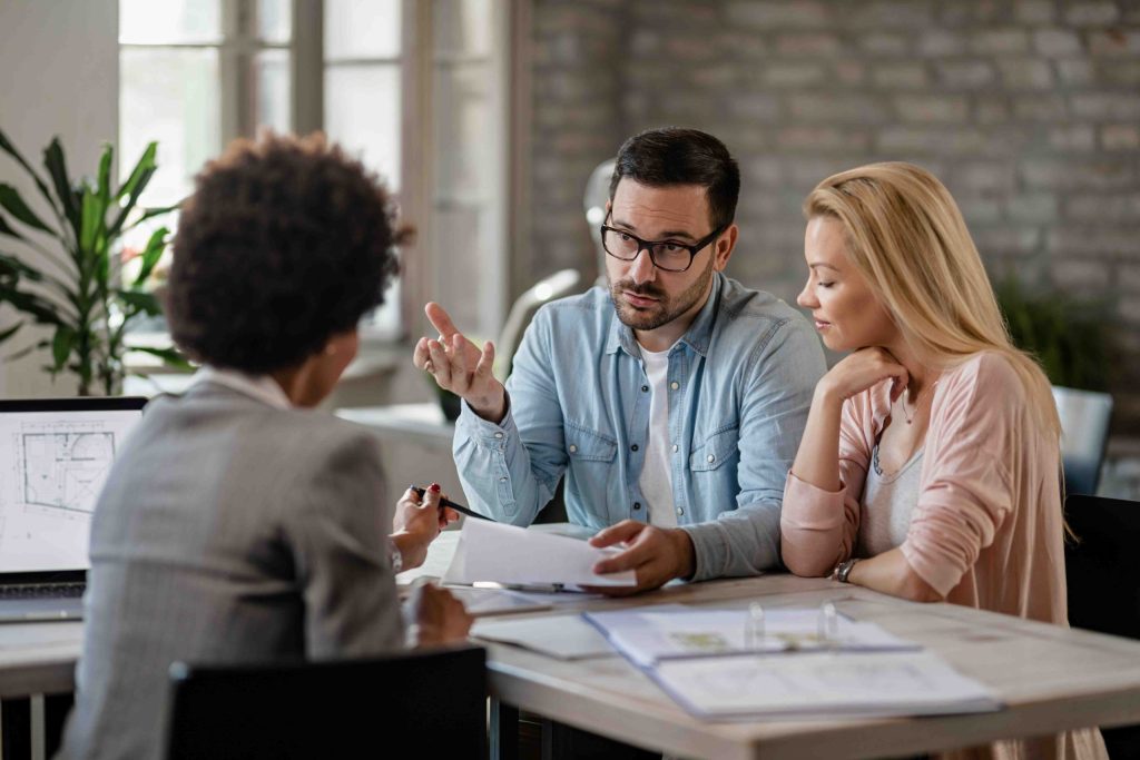 real estate investment advice discussion between couple and property advisor
